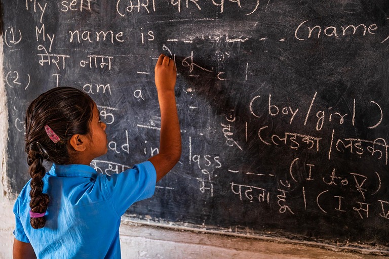 Indian schoolgirl in classroom, English language class, India